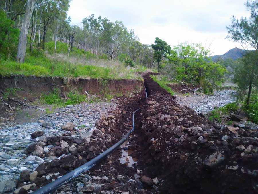 Trench through stony creek crossing